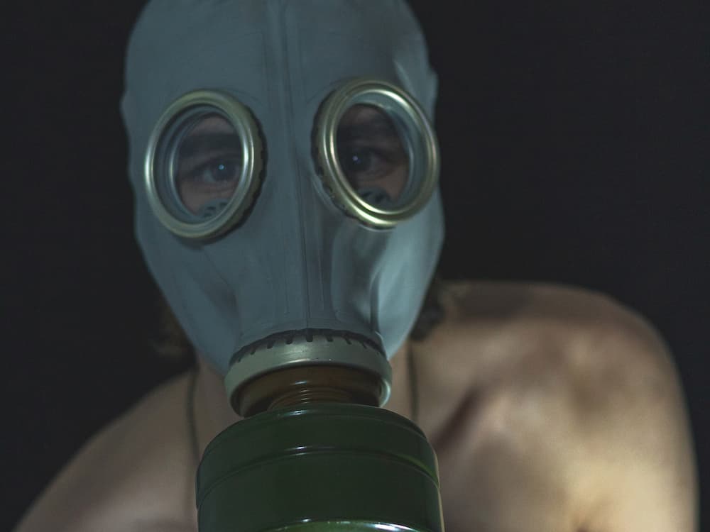 naked man wearing gas mask