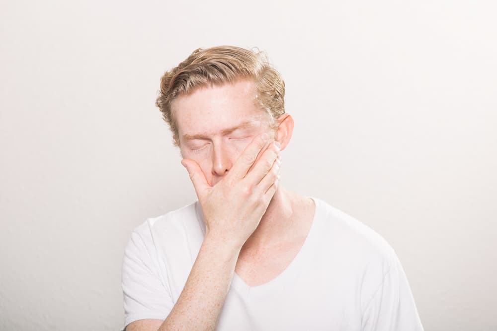 young man suffering from sore throat