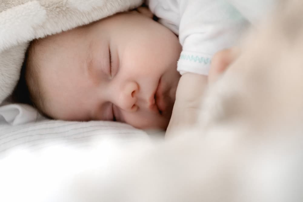 infant baby sleeping covered with blanket