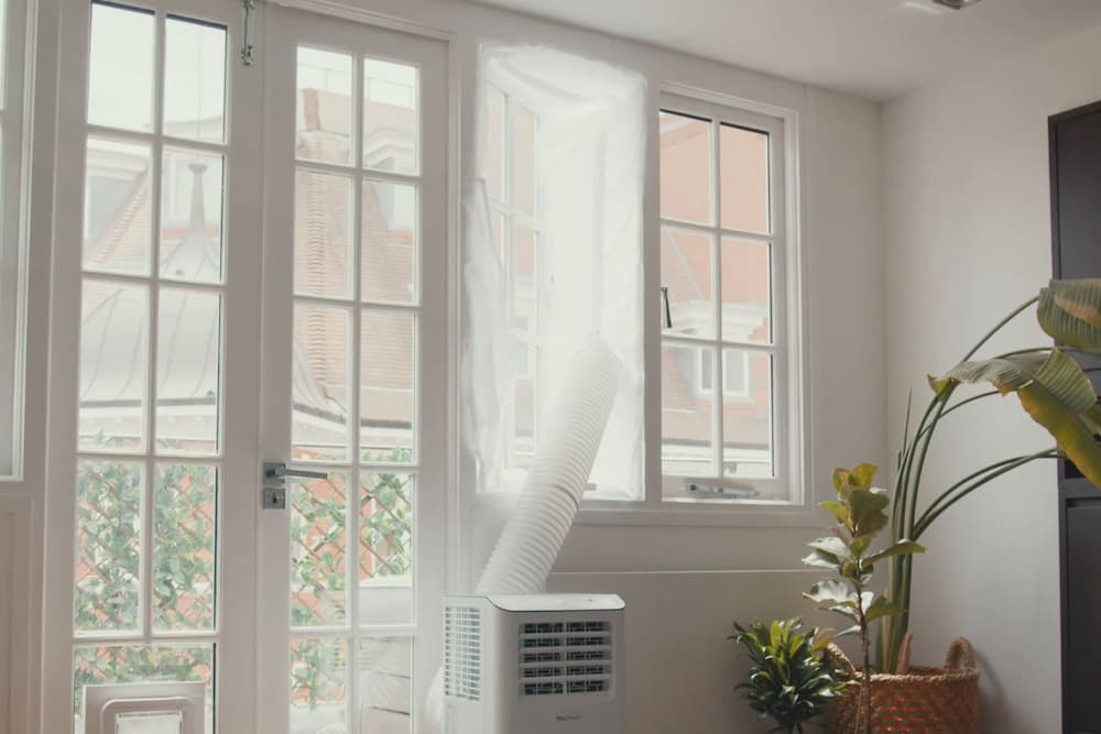 venting portable AC thru hinged window with fabric screen