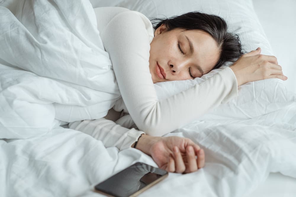 woman sleeping in bed with humidifier
