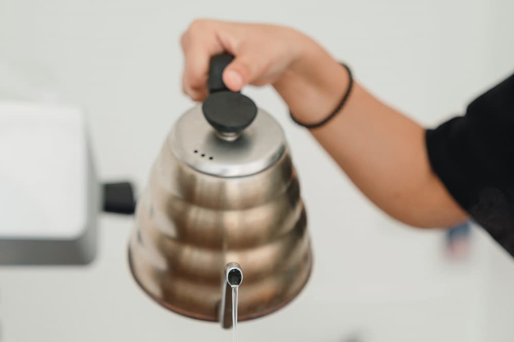 woman pouring hot water in humidifier
